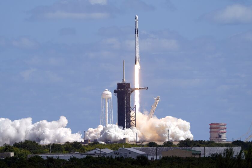 A SpaceX Falcon 9 rocket and the Dragon capsule, with a multinational crew of four astronauts, lifts off from Launch Complex 39-A Wednesday, Oct. 5, 2022, at the Kennedy Space Center in Cape Canaveral, Fla., beginning a five-month mission to the International Space Station. (AP Photo/John Raoux)