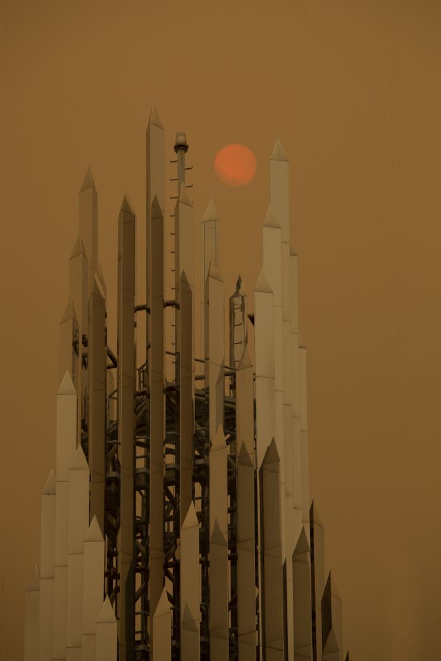 A hazy sun is seen behind the Christ Cathedral in Garden Grove.