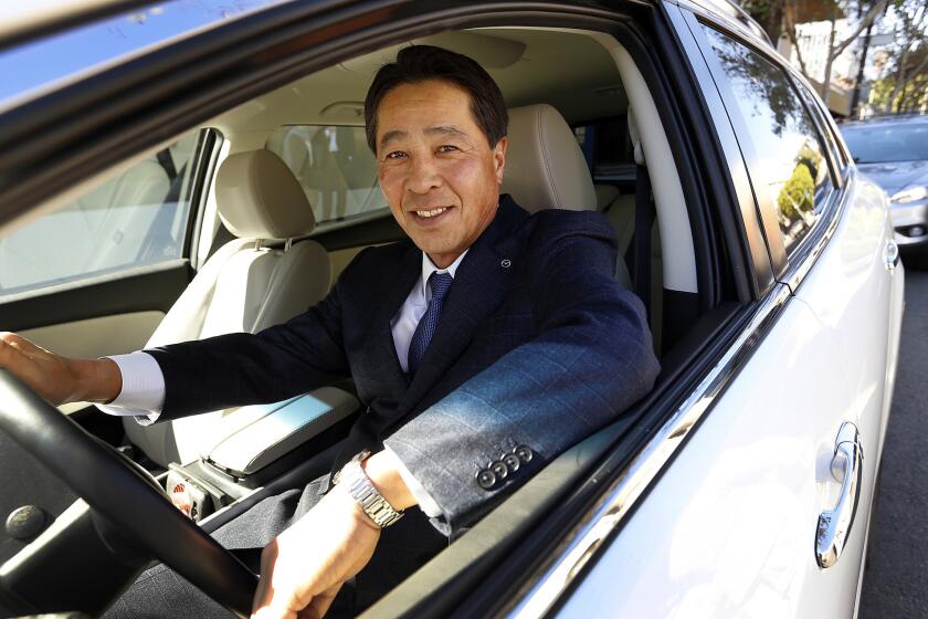 Masamichi Kogai, president and CEO at Mazda Global Motor Corp., is seen in a new Mazda at the Los Angeles Times.