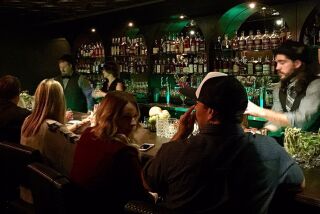 Bartender Chad Lee, right, serves customers on Saturday, Nov. 19, at the newly opened 101 Proof speakeasy inside Urge Gastropub and Whiskey Bank in Oceanside.