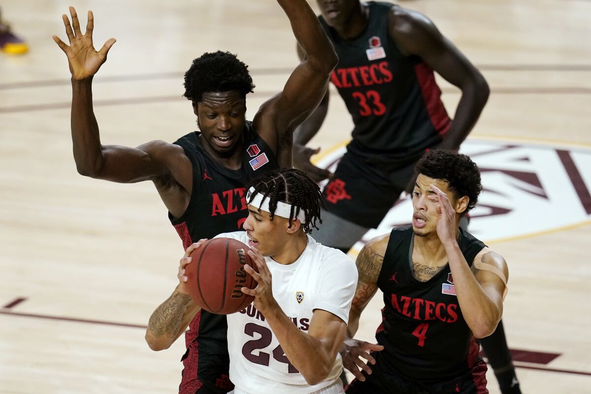 San Diego State forward Nathan Mensah, left, led the Aztecs to a win against Arizona State in 2020.