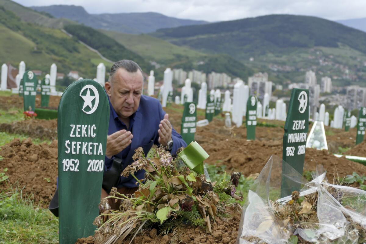 Tarik Svraka visits the graves of relatives who died of COVID-19 in Zenica, Bosnia.