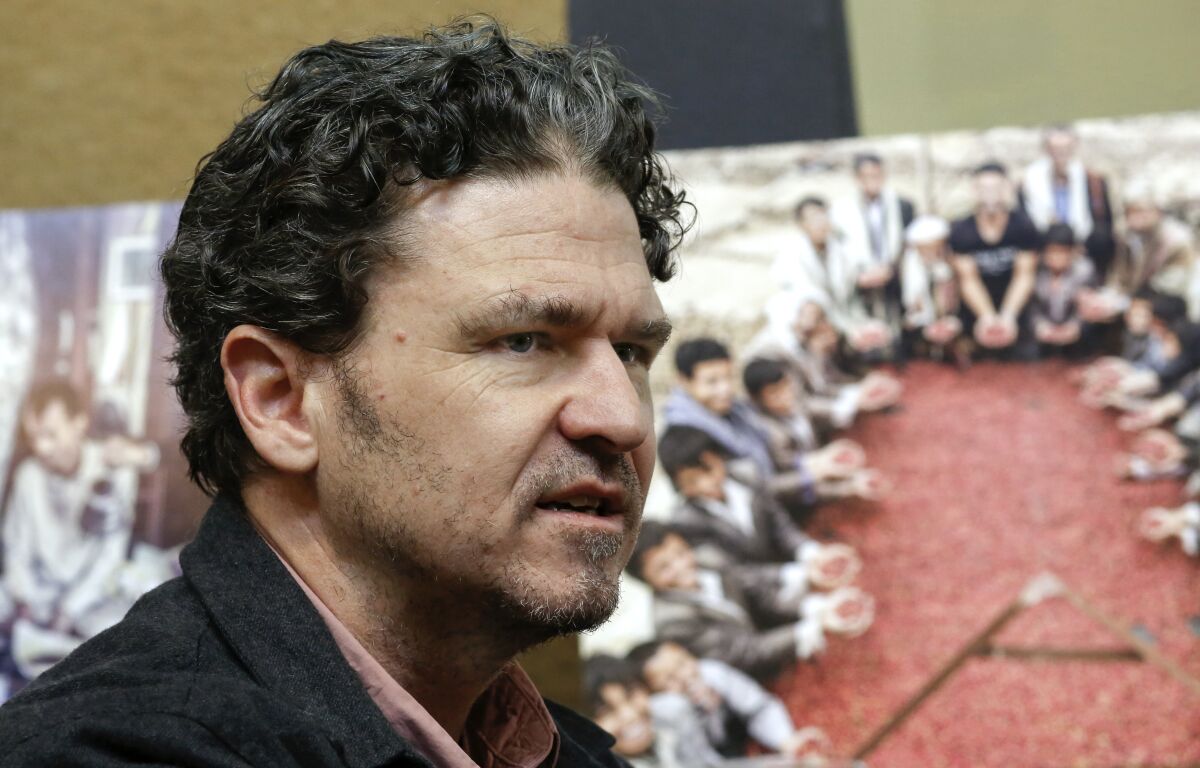 FILE - Author David Eggers talks about his new book, "The Monk of Mokhtar" Tuesday, Jan. 16, 2018 in Oakland, Calif. Best-selling author Dave Eggers is offering high school seniors in South Dakota's second-largest city free copies of his book "The Circle" and copies of four books by other authors that were removed from the district's schools. (Michael Macor/San Francisco Chronicle via AP, File)
