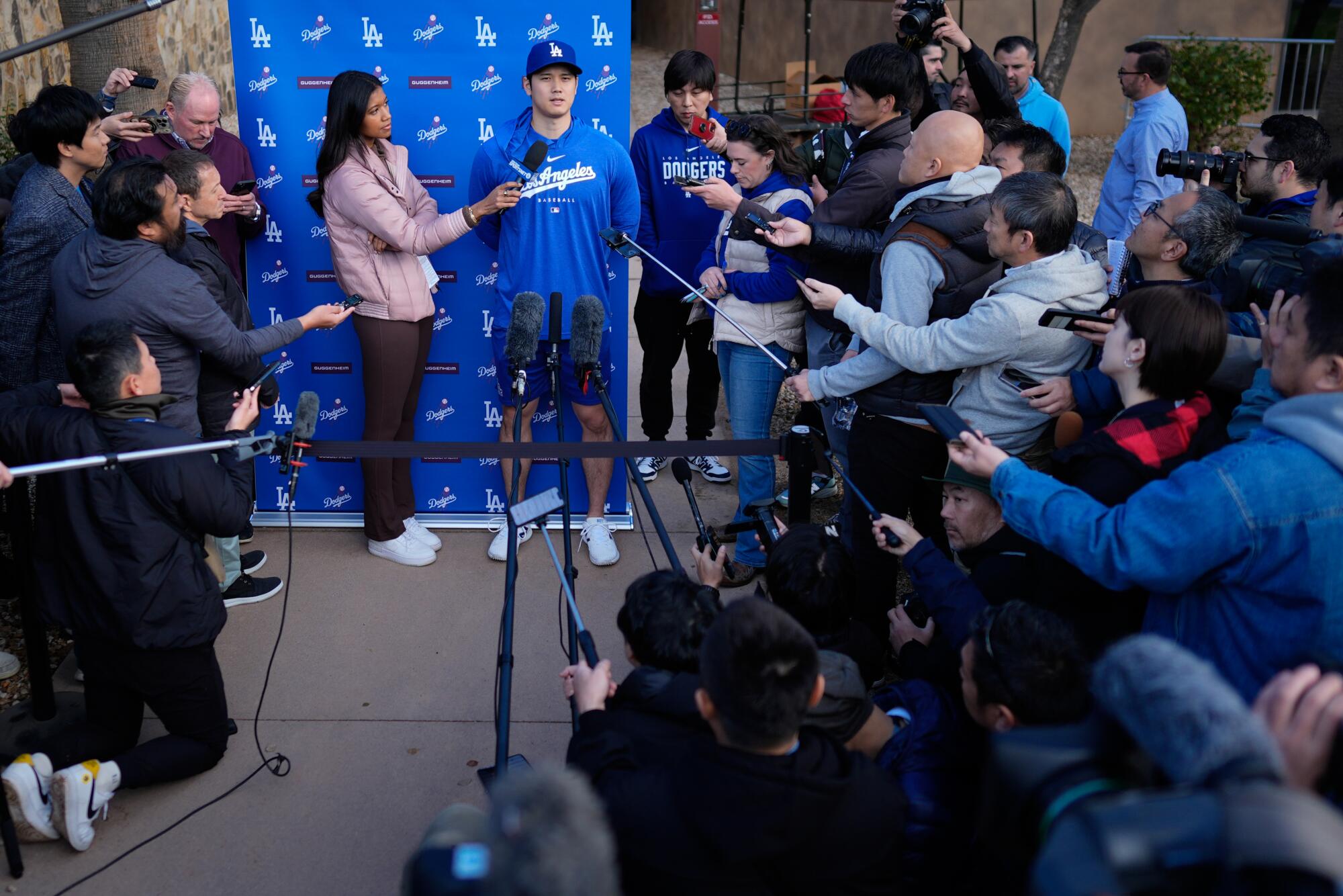The Dodgers' Shohei Ohtani, with interpreter Ippei Mizuhara, right, speaks to the media at Camelback Ranch.