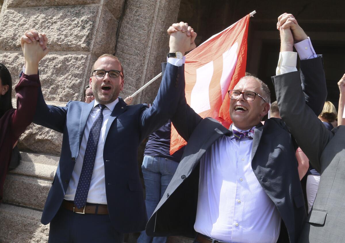 Human Rights Campaign president Chad Griffin. left, and Jim Obergefell, named plaintiff in the historic U.S. Supreme Court same-sex marriage case, cheer during a press conference held at the Texas Capitol in Austin to discuss the local effect of the marriage equality ruling.
