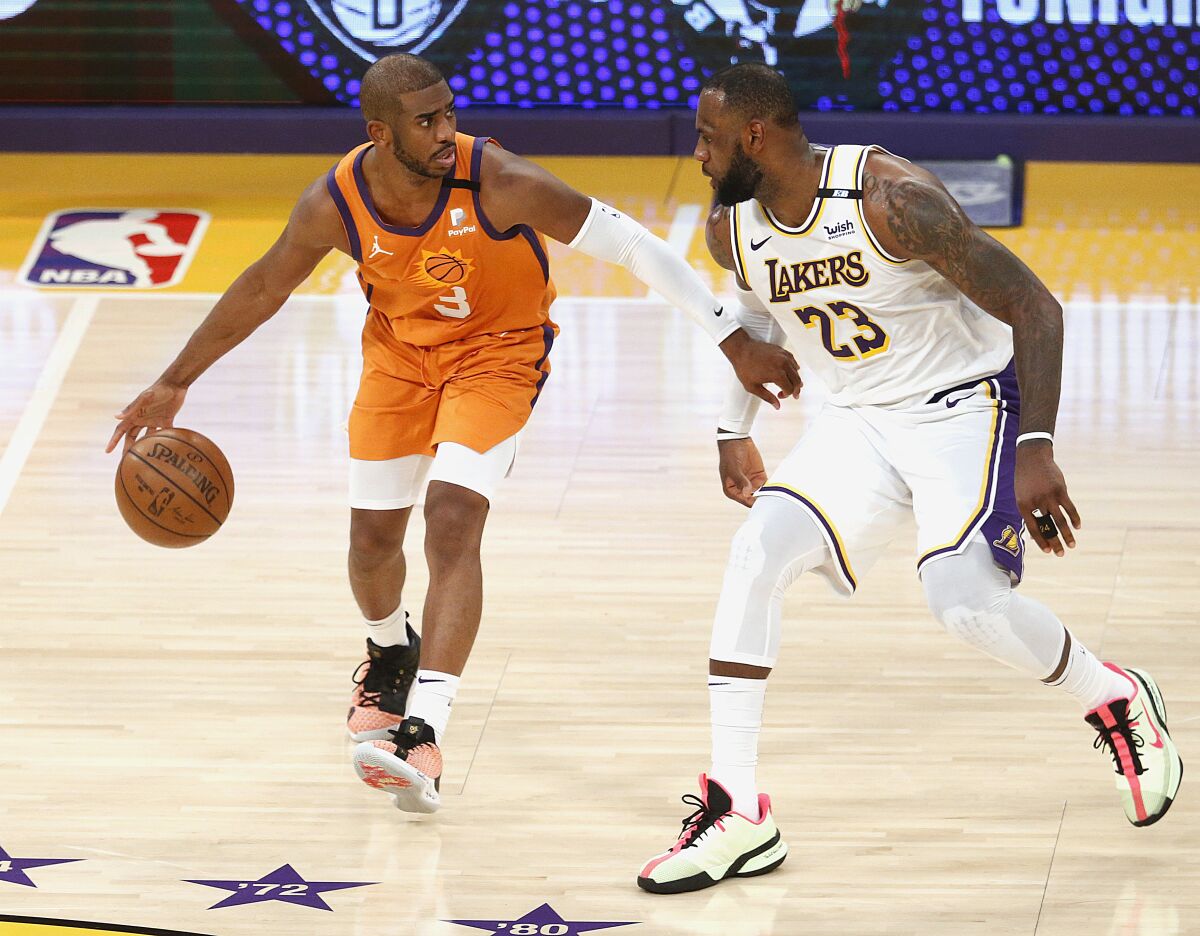 Lakers forward LeBron James defends Suns guard Chris Paul during Game 4.