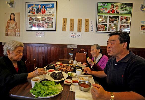 Choon Do Park, left, Young Soon and Joon Yoo dine at Jangchung-Dong Wong Jokbal in Los Angeles' Koreatown.