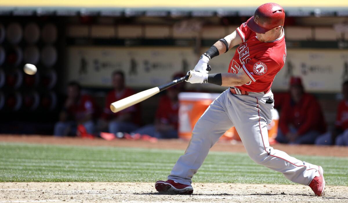 Angels right fielder Kole Calhoun drives in a run with a single against the Athletics in the seventh inning Thursday afternoon in Oakland.