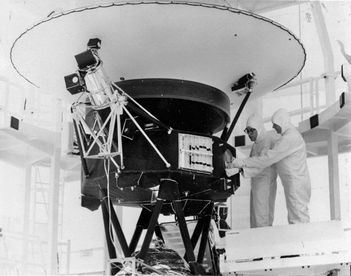 FILE - In this Aug. 4, 1977, photo provided by NASA, the "Sounds of Earth" record is mounted on the Voyager 2 spacecraft in the Safe-1 Building at the Kennedy Space Center, Fla., prior to encapsulation in the protective shroud. NASA is listening for any peep from Voyager 2 after losing contact with the spacecraft billions of miles away. (AP Photo/NASA, File)