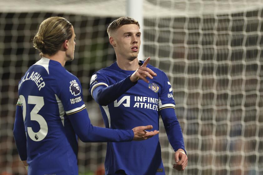 Chelsea's Conor Gallagher, left, and Chelsea's Cole Palmer during the English Premier League soccer match between Chelsea and Everton at Stamford Bridge stadium in London, Monday, April 15, 2024. (AP Photo/Ian Walton)