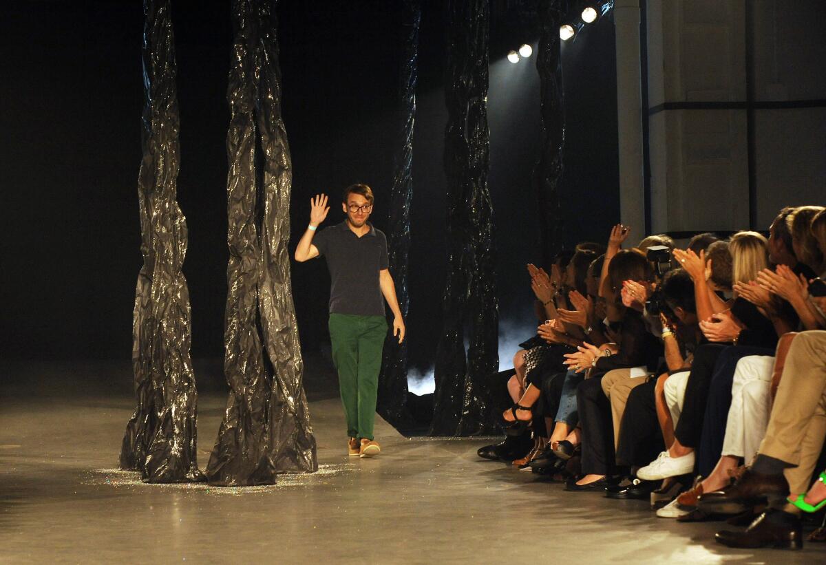 Band of Outsiders founder and creative director Scott Sternberg waves to the audience at a September 2012 runway show in New York City. The company that now owns the label's intellectual property has announced plans to relaunch the brand for spring 2017.
