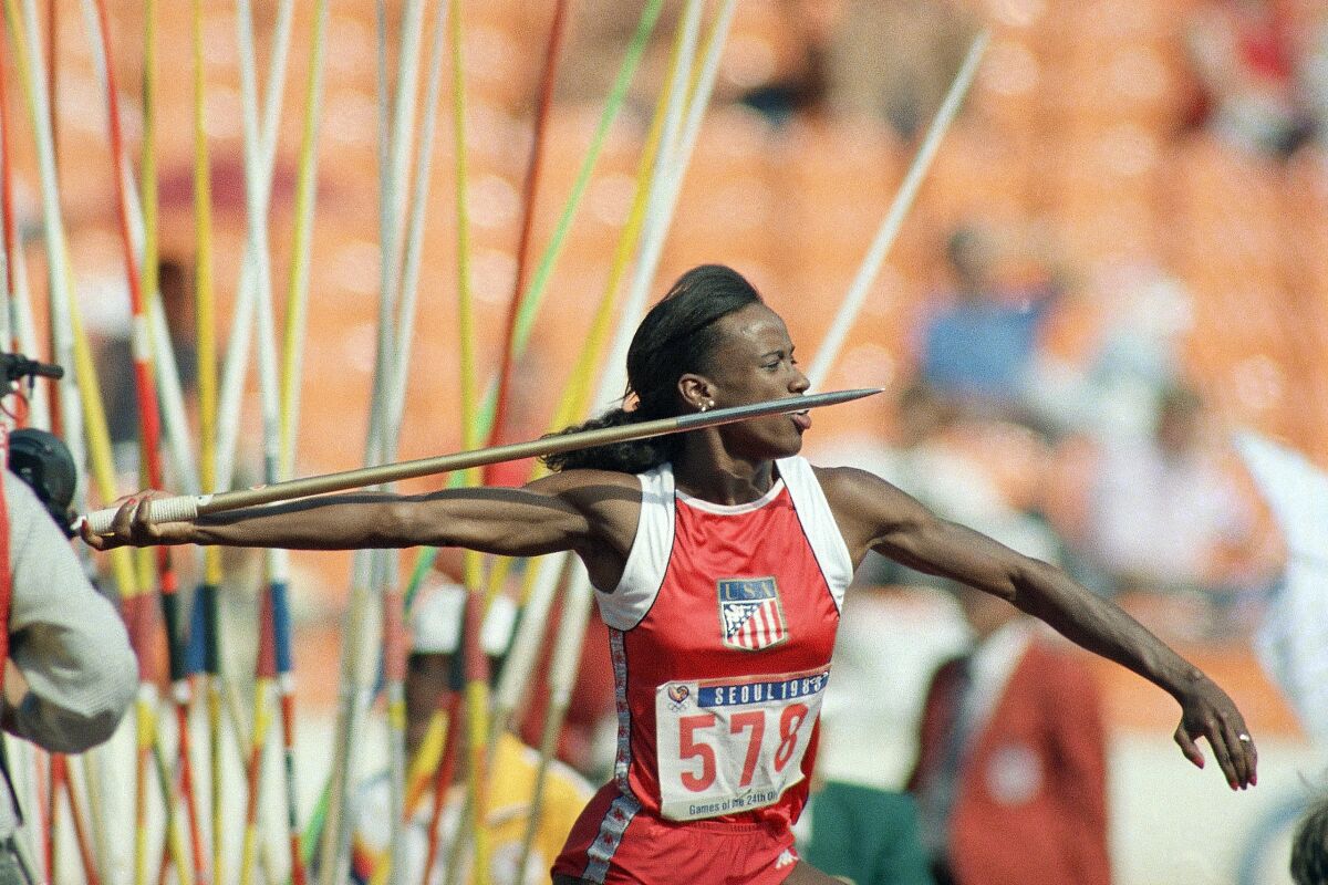 A woman makes a javelin throw during a heptathlon competition 