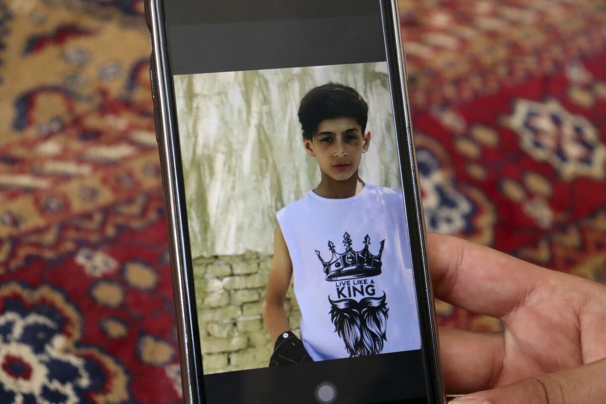 Emal Ahmadi shows a photo of his family member who was killed during a U.S. drone strike on their home last Sunday, , at his home in Kabul, Afghanistan, Thursday, Sept. 2, 2021. Ahmadi says Sunday's U.S. drone strike killed 10 members of his family, six of them children. Senior U.S. military officials said the drone strike hit an Islamic State target and disrupted the extremist' ability to further disrupt the final phase of the U.S. withdrawal from Afghanistan. (AP Photo/Khwaja Tawfiq Sediqi)