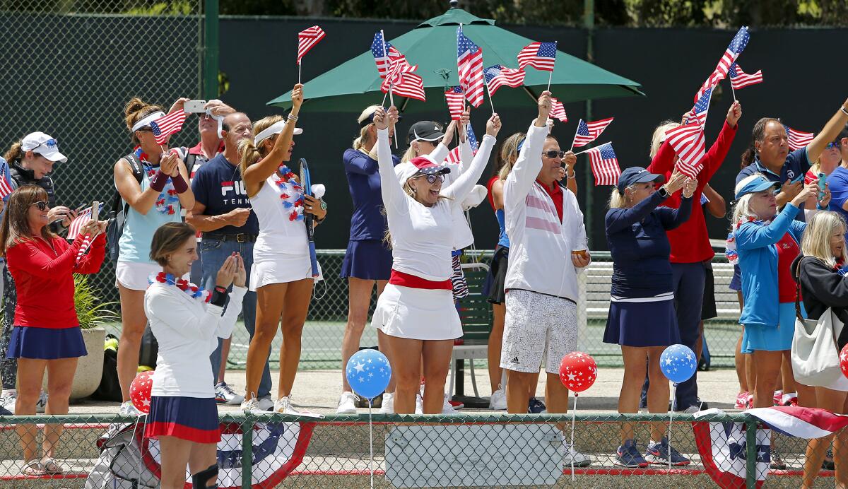 Club members cheer on Vietnam War veteran Bob Stack  on Saturday at Palisades Tennis Club in Newport Beach.