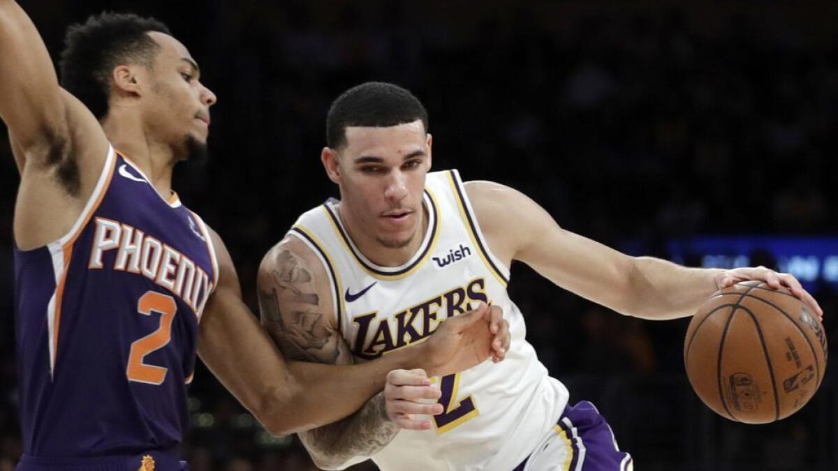 Lakers' Lonzo Ball, right, is defended by Phoenix's Elie Okobo on Dec. 2 at Staples Center.