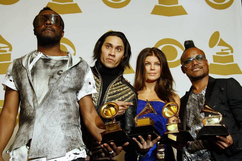 The Black Eyed Peas attend the 52nd annual Grammy Awards in 2010. Three members of the band -- will.i.am, left; Taboo, second from left; and apl.de.ap, right -- have filed a federal lawsuit against their former business manager, Sean M. Larkin. Band member Fergie, second from right, is not involved in the lawsuit.