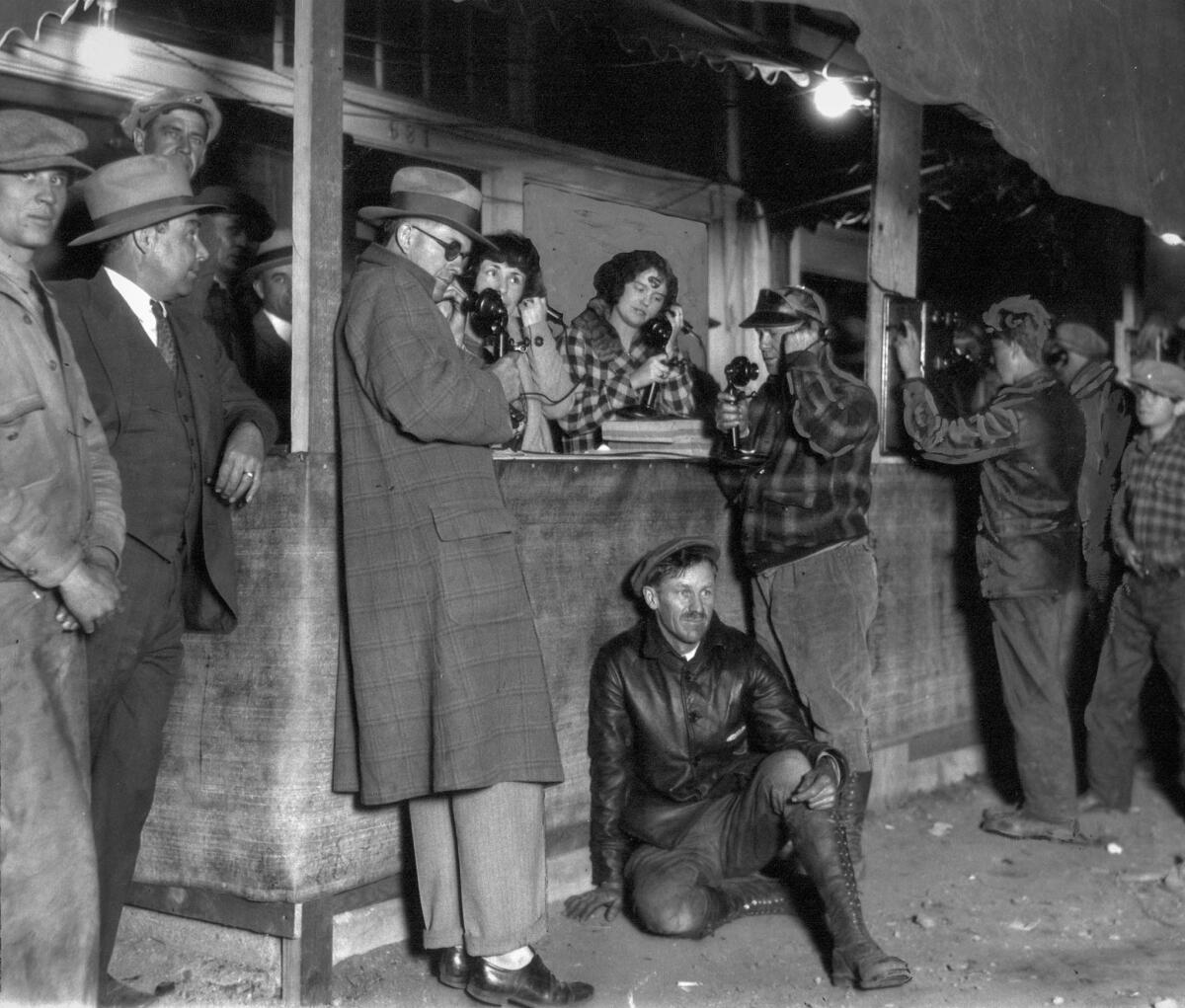 March 14, 1928: Residents try to reach loved ones at an emergency phone station afterthe collapse of St. Francis Dam.