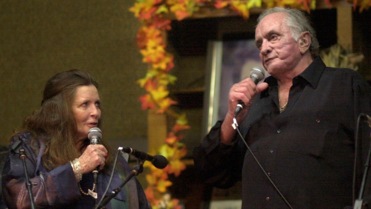 June Carter Cash and husband Johnny Cash perform in Hiltons, Va., in 2002. Johnny Cash's previously unpublished writings are the source of a new album, "Johnny Cash: Forever Words," featuring a raft of country, rock and bluegrass musicians.