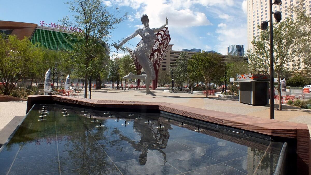 Reflected in a pool, "Bliss Dance" in its new home at the Park, an entertainment district between the New York-New York and Monte Carlo hotel-casino resorts.
