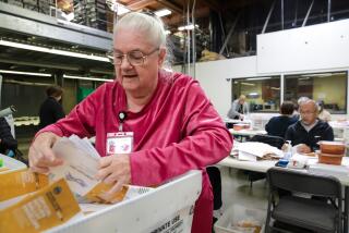 Santa Ana, CA - November 09: Jeanette Harris sorts ballots at Vote-By-Mail ballot processing center at Orange County Registrar of Voters on Wednesday, Nov. 9, 2022 in Santa Ana, CA. (Irfan Khan / Los Angeles Times)