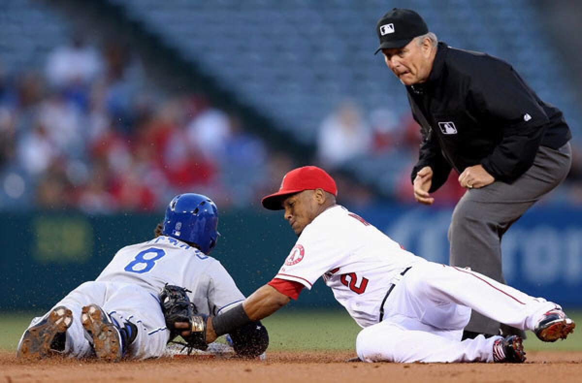 Royals third baseman Mike Moustakas slides safety into second base with a double ahead of the tag by Angels shortstop Erick Aybar in the second inning Wednesday night.