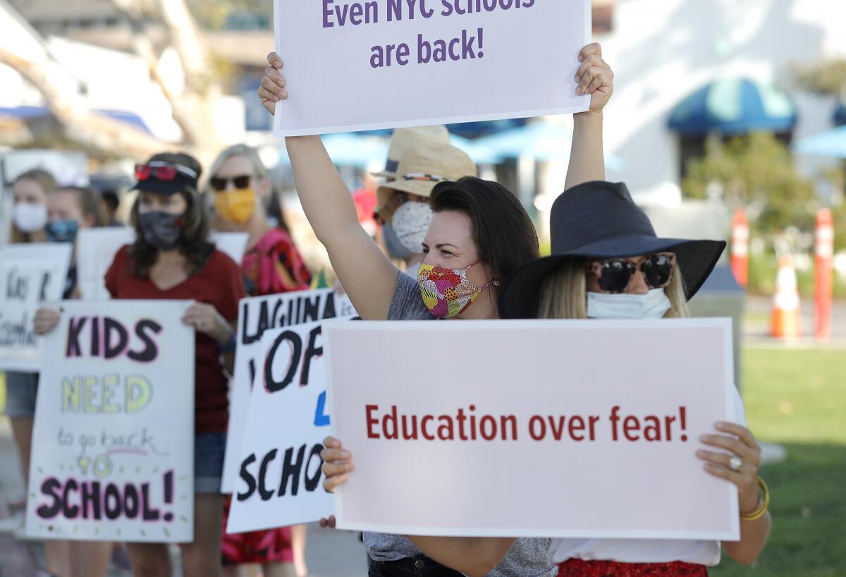 Laguna Beach parents demonstrate to open Thurston Middle School and Laguna Beach High School on Friday at Main Beach.