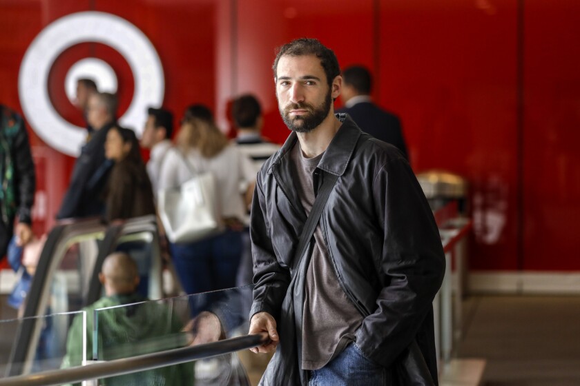 Justin Orkin works in the grocery department at a Target store in downtown Los Angeles. Labor unions and worker advocates are mounting a "Fair Workweek" campaign to curb what they see as abusive scheduling practices in the retail industry.
