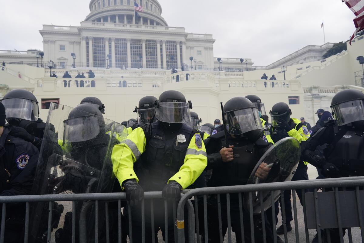 Police try to hold back protesters in front of the U.S. Capitol in Washington on Jan. 6. 