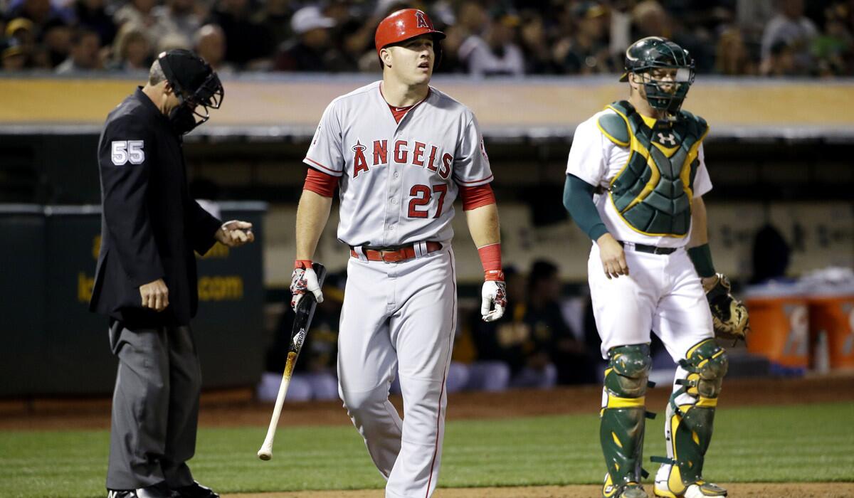 Angels' Mike Trout walks back to the dugout after striking out during the Angels' 6-2 loss to the Oakland Athletics on Tuesday.