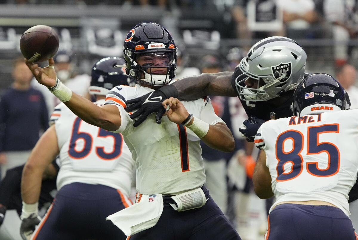 Las Vegas Raiders defensive end Yannick Ngakoue breaks up a pass attempt by Chicago Bears quarterback Justin Fields.