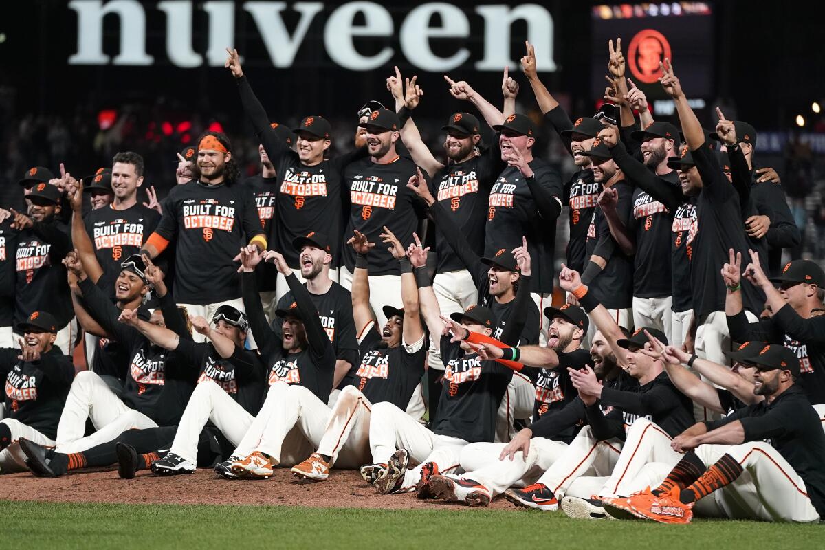 San Francisco Giants players celebrate after defeating the San Diego Padres in a baseball game to clinch a postseason berth in San Francisco, Monday, Sept. 13, 2021. (AP Photo/Jeff Chiu)