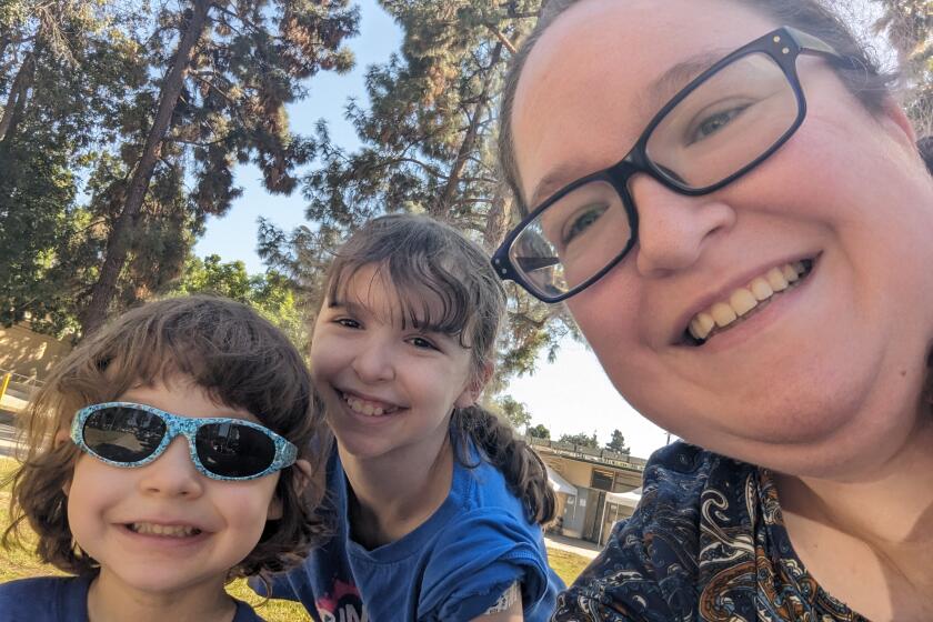 Anne Hamilton con sus dos hijos, Katie Hamilton y Jimmy Hamilton, en una clínica de vacunación temporal administrada por al Departamento de Salud Pública del Condado de Los Ángeles en el parque Eugene A. Obregón el 12 de octubre de 2023.
