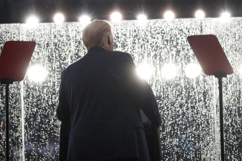 President Donald Trump speaks in the rain behind glass during an Independence Day celebration in front of the Lincoln Memorial, Thursday, July 4, 2019, in Washington. (AP Photo/Carolyn Kaster)
