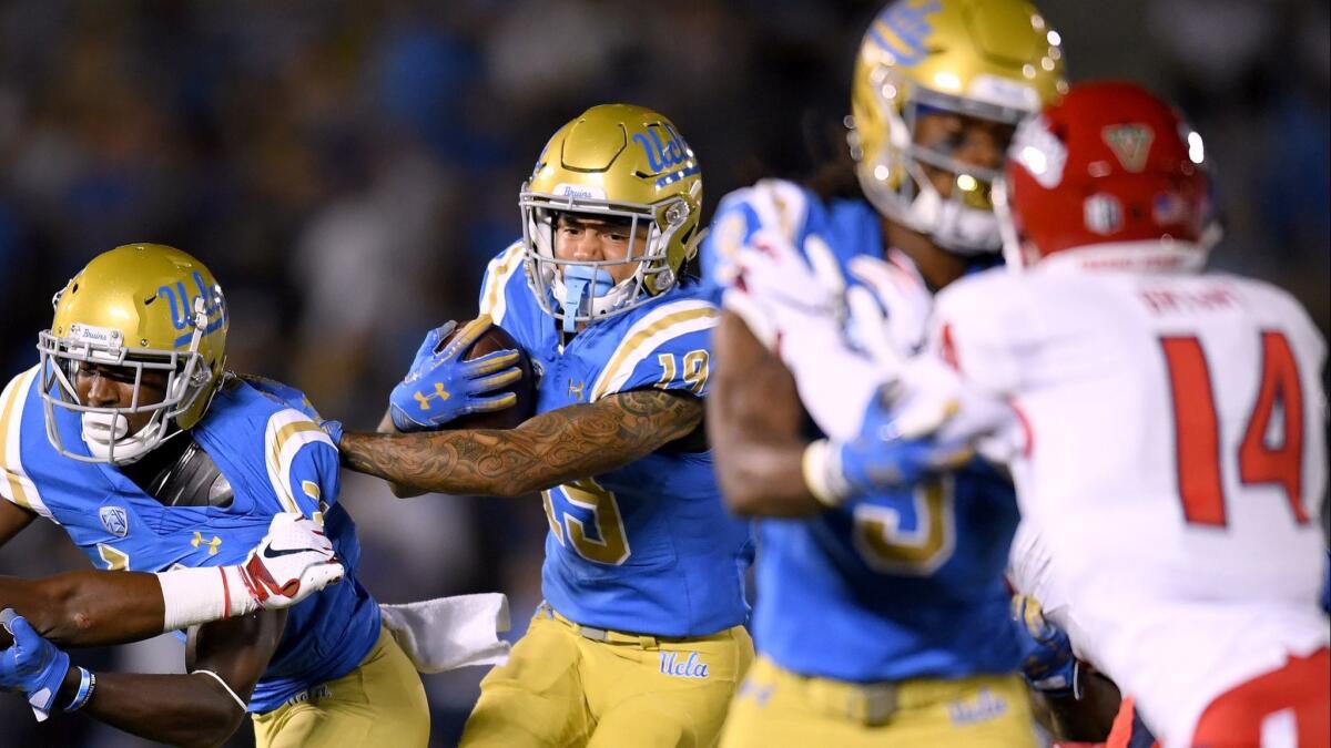 UCLA's Kazmeir Allen follows a block during the second quarter against Fresno State at the Rose Bowl on Saturday.