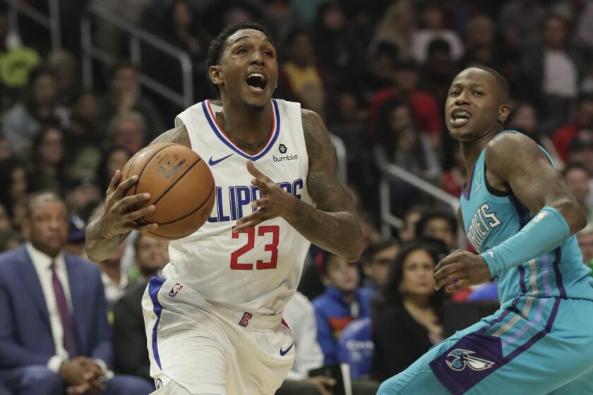 LOS ANGELES, CA, MONDAY, OCTOBER 28, 2019 - LA Clippers guard Lou Williams (23) dives past Charlotte Hornets guard Terry Rozier (3) during second half action at Staples Center.(Robert Gauthier/Los Angeles Times)