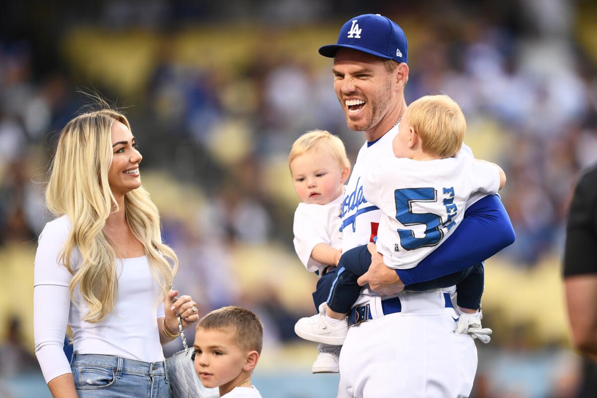 The Dodgers' Freddie Freeman looks on with his wife, Chelsea, and sons before a game against the Braves on April 18, 2022.