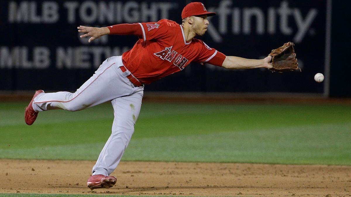 Angels shortstop Andrelton Simmons flips the ball to second baseman Danny Espinosa on a ball hit by Oakland Athletics' Rajai Davis during the fifth inning on April 5.