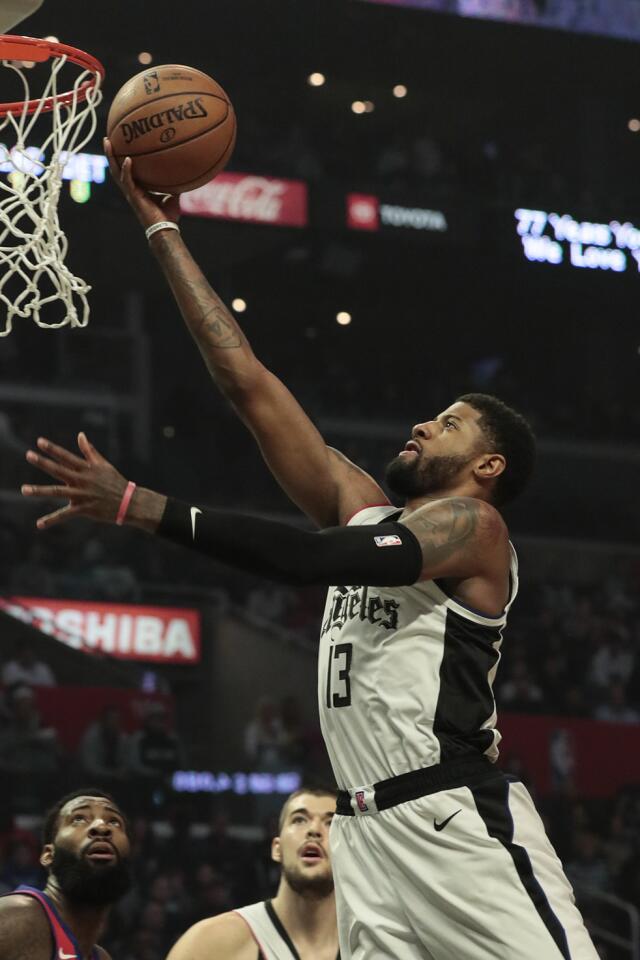 Clippers forward Paul George drives to the basket against the Detroit Pistons in the first half.