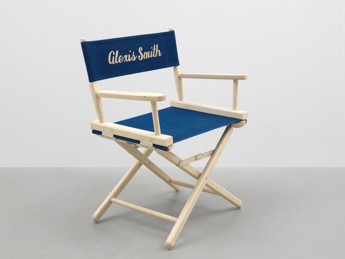 A blue and white director's chair, with the words Alexis Smith on the top.