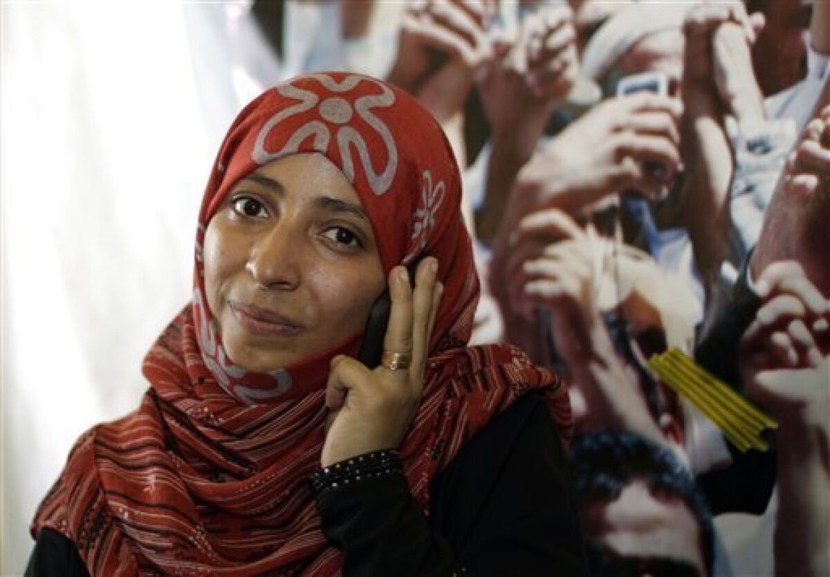 Yemeni activist Tawakkul Karman speaks on the telephone after the announcement of the 2011 Nobel Peace Prize in Sanaa, Yemen, Friday, Oct. 7, 2011. The 2011 Nobel Peace Prize was awarded Friday to Liberian President Ellen Johnson Sirleaf, Liberian peace activist Leymah Gbowee and Tawakkul Karman of Yemen for their work on women's rights. (AP Photo/Hani Mohammed)