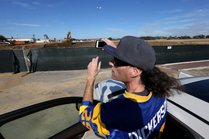 Longtime Rams football fan Dave Frazier, 50, visits the site of a new NFL stadium under construction near the Forum in Inglewood.