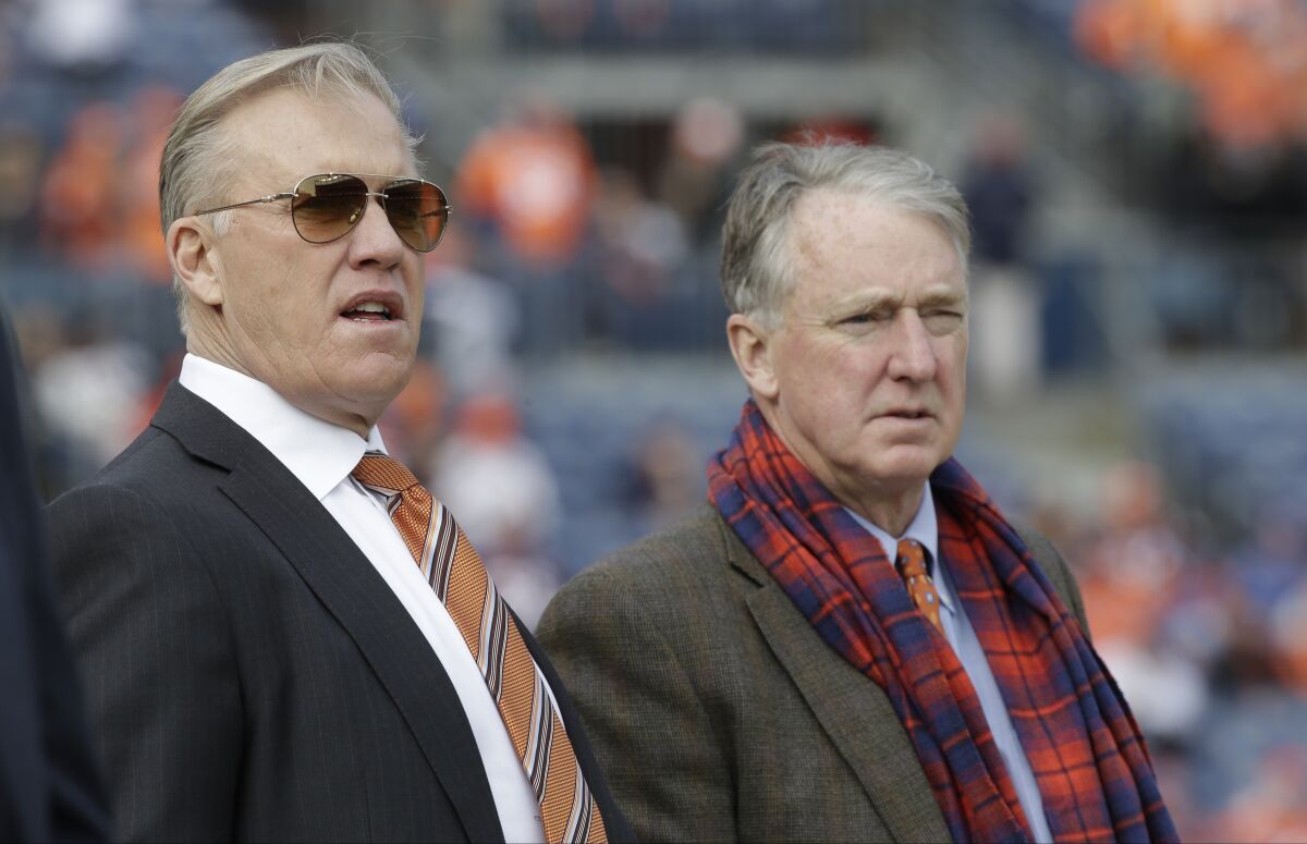 FILE - Denver Broncos general manager John Elway, left, stands with Broncos President and CEO Joe Ellis before an NFL football game against the Oakland Raiders in Denver, Jan. 1, 2017. John Elway is refuting Brian Flores' claim in a lawsuit that his interview with the Denver Broncos in 2019 was a sham and only conducted to satisfy the NFL's Rooney Rule. Flores said in the lawsuit that Elway, then the team's general manager, and president/CEO Joe Ellis showed up an hour late for his interview at a Providence, Rhode Island hotel, and they “looked completely disheveled and it was obvious that they had been drinking heavily the night before.” (AP Photo/Jack Dempsey, File)