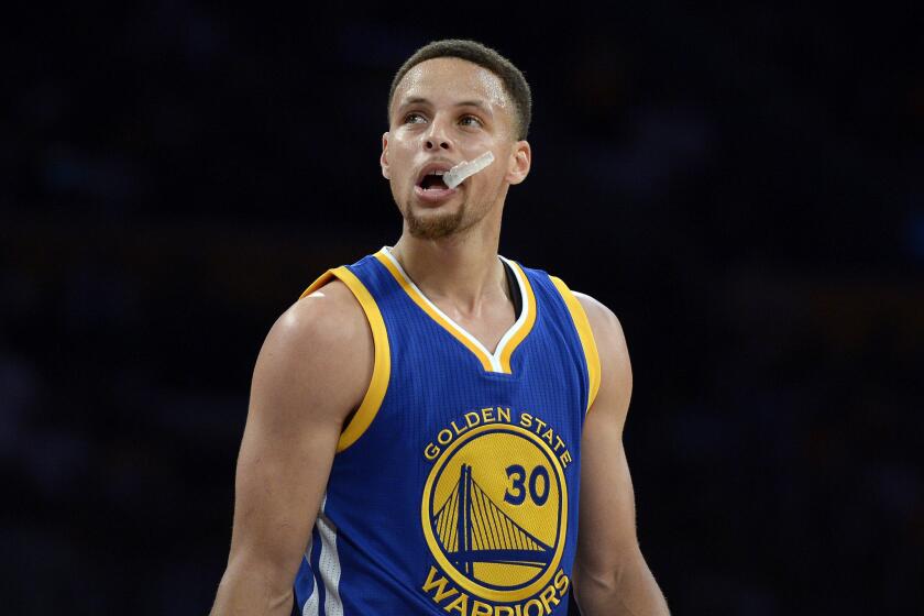 Warriors guard Stephen Curry reacts as he looks at the scoreboard at the end of the first quarter of a game against the Lakers on March 6 at Staples Center.