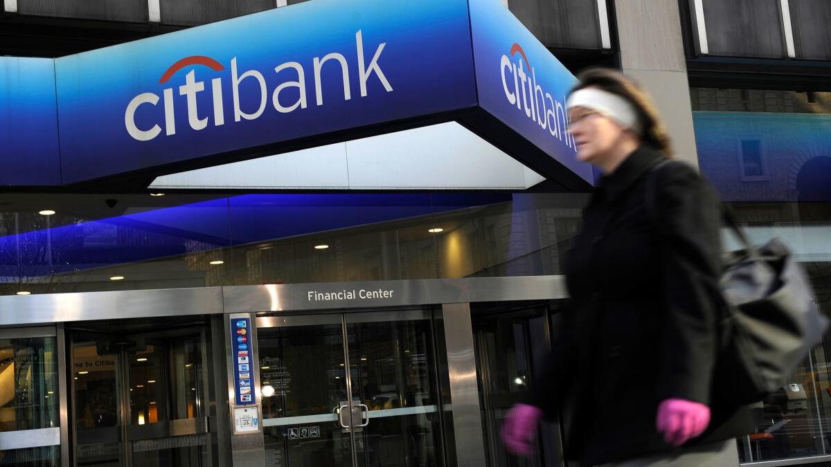 A woman walks past a Citibank branch at the U.S. bank Citigroup world headquarters on Park Avenue in New York in this 2008 file photo.