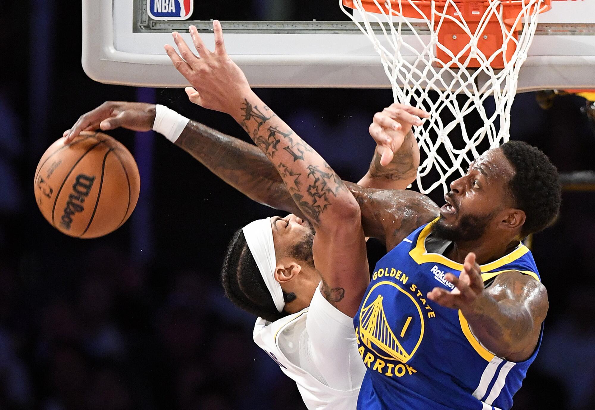 Anthony Davis is fouled hard by the Warriors' JaMychal Green in the first quarter.