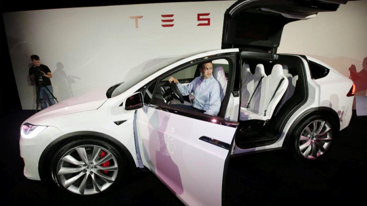 A Tesla Motors executive displays the Model X in Fremont, Calif., on Sept. 29.