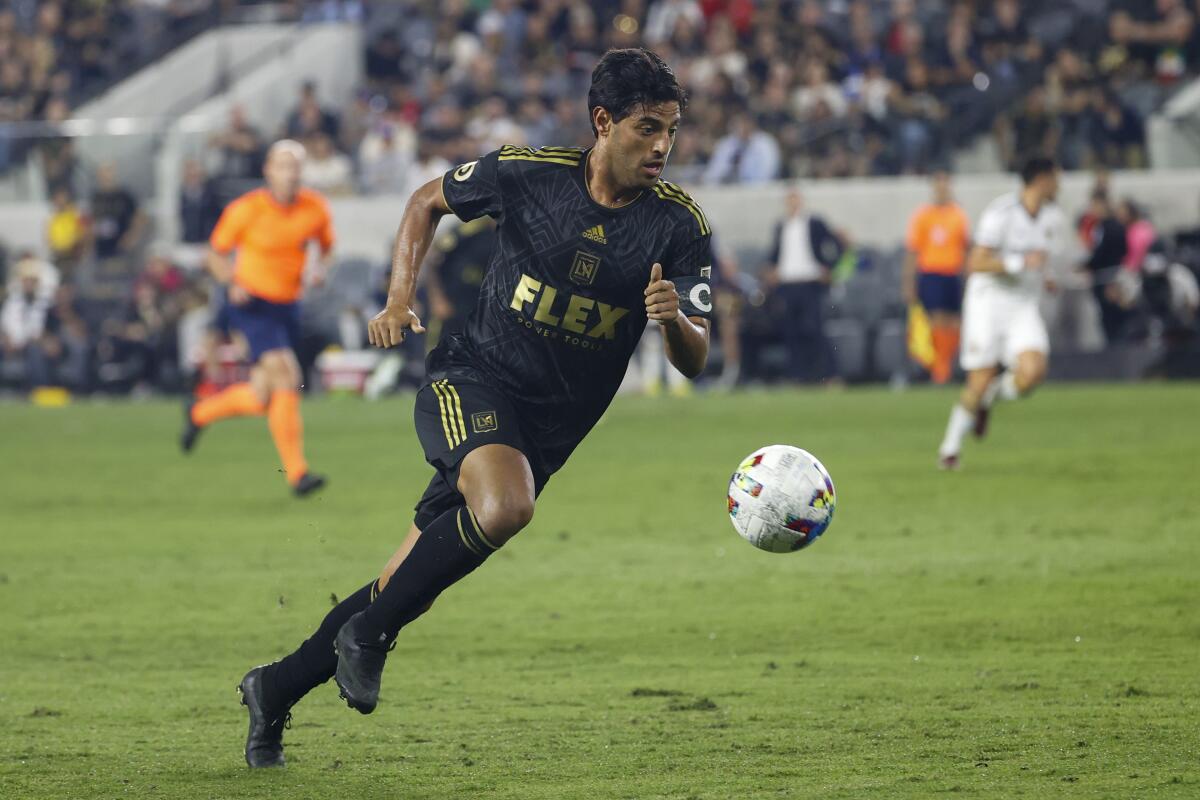 Carlos Vela controls the ball during a playoff match against the Galaxy in October 2022.