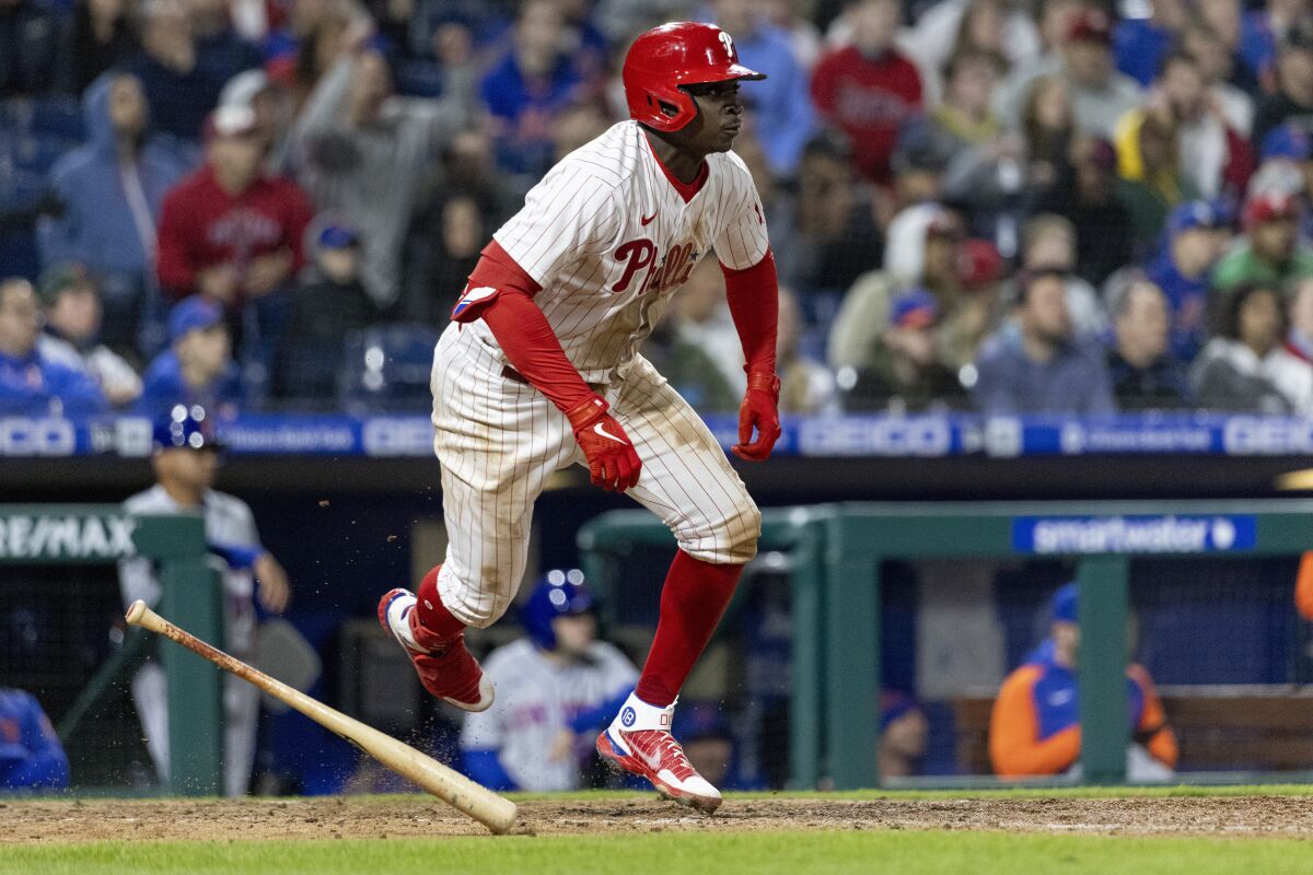 Philadelphia Phillies' Didi Gregorius (18) runs to first on an RBI double during the eighth inning of a baseball game against the New York Mets, Monday, April 11, 2022, in Philadelphia. (AP Photo/Laurence Kesterson)