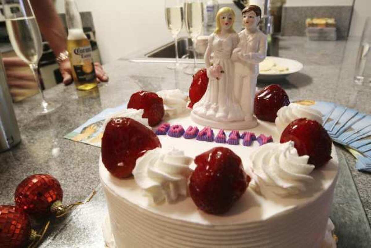 A cake topper of two women sits atop a cake at a bachelorette party for the couple in New York.
