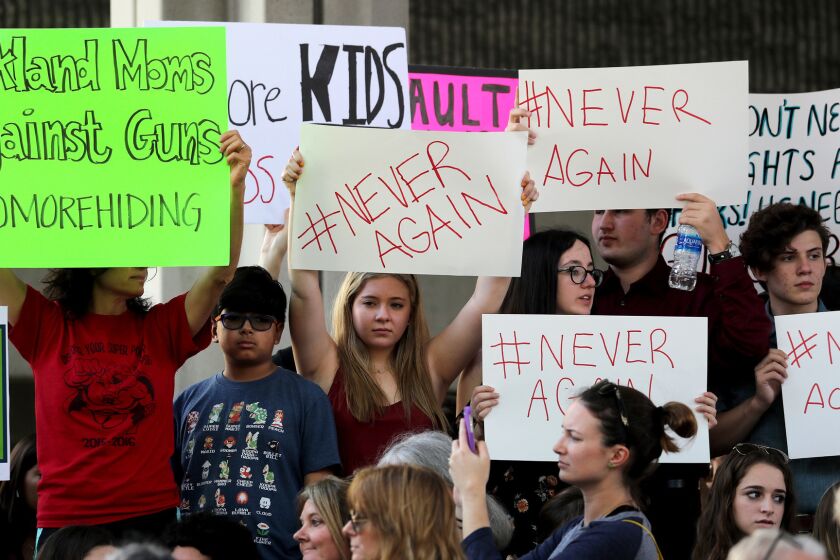 Protesters attend a rally at the Federal Courthouse in Fort Lauderdale, Fla., to demand government action on firearms, on Saturday, Feb. 17, 2018. Their call to action is a response the massacre at Marjory Stoneman Douglas High School in Parkland, Fla. (Mike Stocker/Sun Sentinel/TNS) ** OUTS - ELSENT, FPG, TCN - OUTS **
